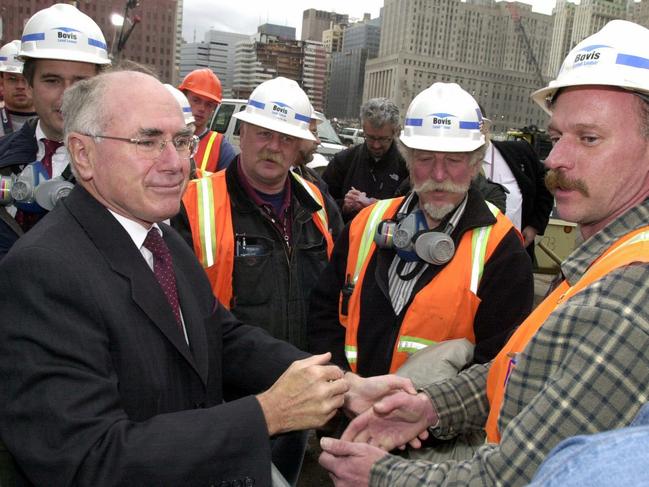 30/1/2002. John Howard clasps the hand of workers at the World Trade Centre site during a tour of the scene.