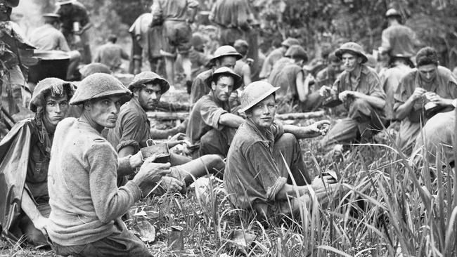 South Australian 2/27th Battalion soldiers photographed beside the Kokoda Track at Itiki, 4km south of Owers’ Corner, a day after emerging from the jungle in the Owen Stanley Ranges of New Guinea on September 21, 1942. The 311 men lost an average of 13kg each on their two-week trek to safety. The men had washed, shaved, eaten and had been issued with clean uniforms by the time this photograph was taken. The remnants of their old uniforms were burnt. (AWM027017)