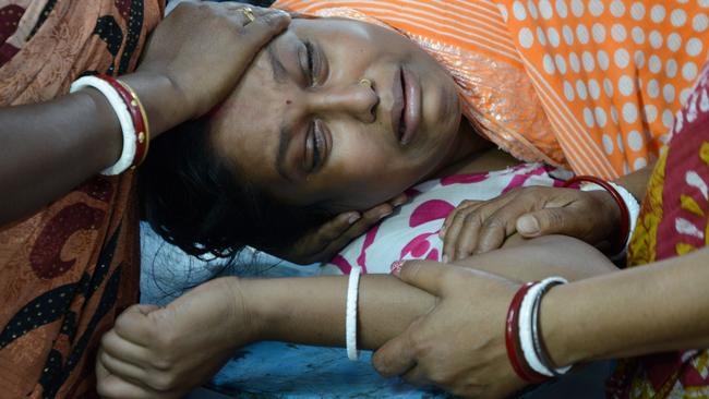 Indian resident Lucy Singh Biswas is comforted by relatives at Siliguri Hospital after she broke her leg by falling down stairs when an earthquake hit Siliguri on April 13, 2016 Myanmar was struck by a magnitude 6.9 quake on April 13, the US Geological Survey reported, with tremors in India and China sending residents rushing out into the streets. / AFP PHOTO / DIPTENDU DUTTA