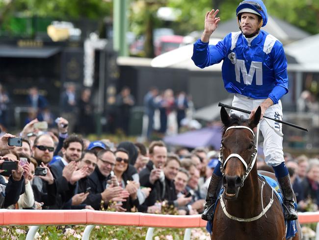 Racegoers applaud Hugh Bowman and Winx after their mind-blowing victory. Picture: Nicole Garmston