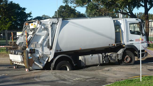 A garbage truck falls into a busted water mains sink hole in Narrabeen, Wednesday, July 29, 2020. Picture: NCA NewsWire / Jeremy Piper