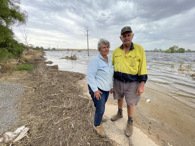 Joanne and Barry Pfeiffer in front of their farm at Murray Bridge which is underwater after the Long Flat levee breached on January 7. Photo: Dylan Hogarth.