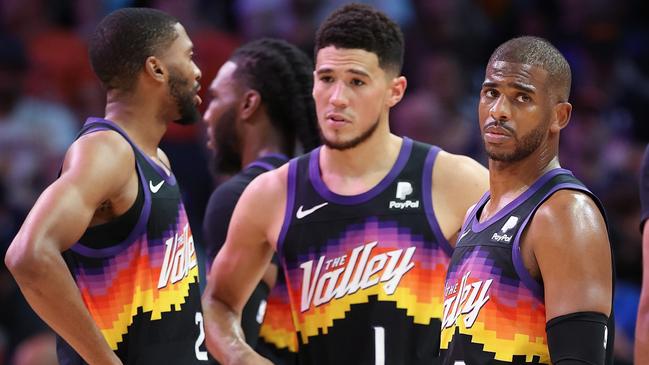 PHOENIX, ARIZONA - MAY 15: Chris Paul #3 of the Phoenix Suns stands on the court with Mikal Bridges #25, Devin Booker #1 and Cameron Johnson #23 during the first half of Game Seven of the Western Conference Second Round NBA Playoffs at Footprint Center on May 15, 2022 in Phoenix, Arizona. The Mavericks defeated the Suns 123-90. NOTE TO USER: User expressly acknowledges and agrees that, by downloading and or using this photograph, User is consenting to the terms and conditions of the Getty Images License Agreement. (Photo by Christian Petersen/Getty Images)