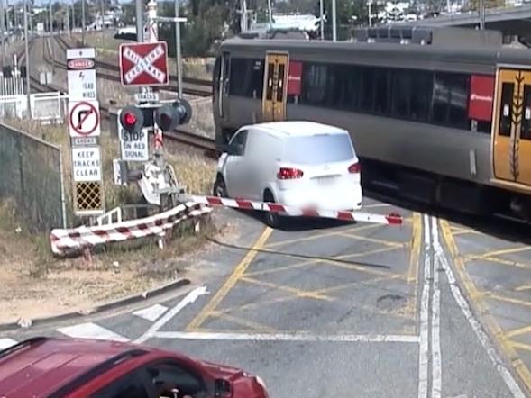 The vehicle comes within inches of the train.