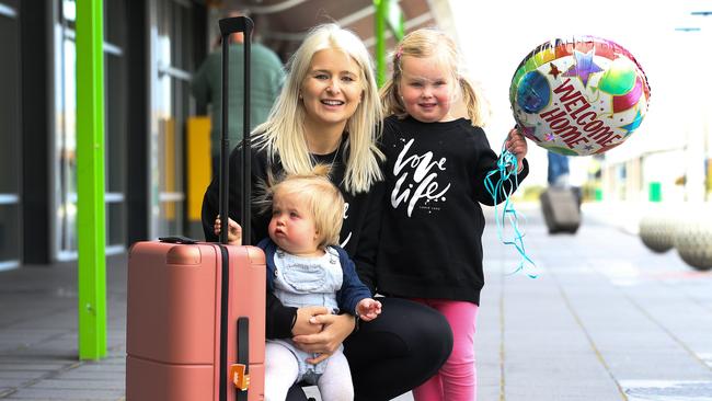 Sisters Nina, 1 and Sadie Myors, 4 are reunited with their aunty Emily Myors. Picture: Zak Simmonds