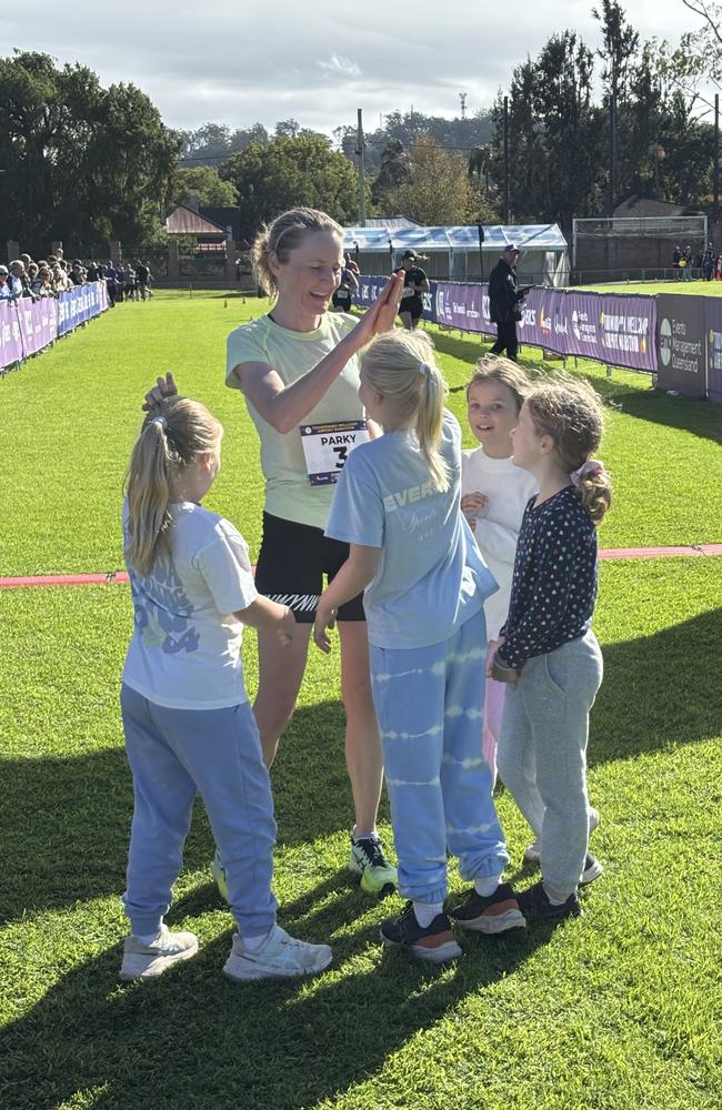 Kathryn Parkinson celebrates winning the Toowoomba Wellcamp Airport Marathon with her children