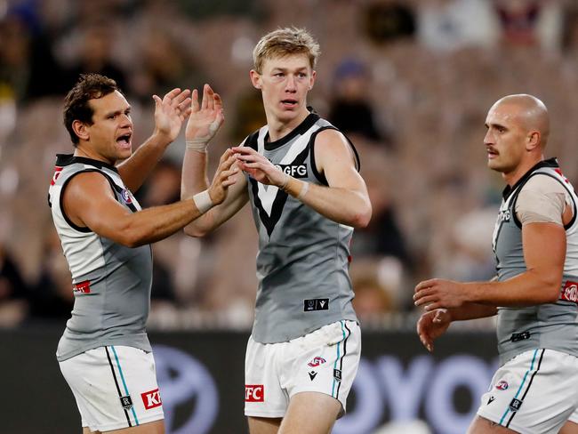 Motlop celebrates a goal with Todd Marshall in June against Richmond. Picture: Dylan Burns/AFL Photos via Getty Images.