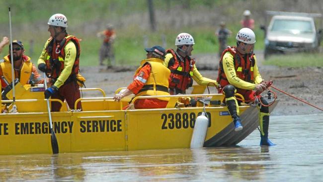 FLASHBACK: Queensland Fire & Rescue Swift Water Rescue Team at location of a submerged utility preparin to secure the vehicle. Picture: MARTINELLI DAVID