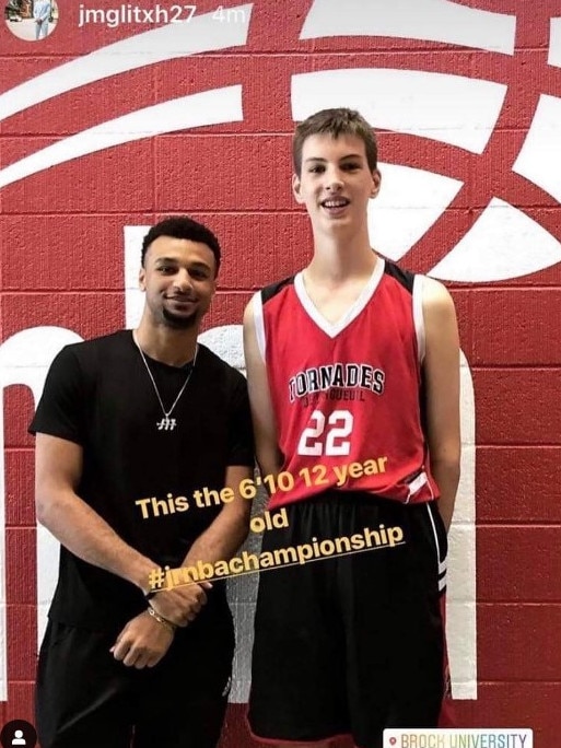 Rioux towering over 193cm NBA champion Jamal Murray.