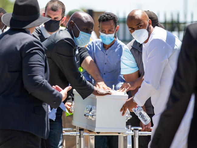 A small coffin being taken to the waiting hearse. Picture: Sarah Matray