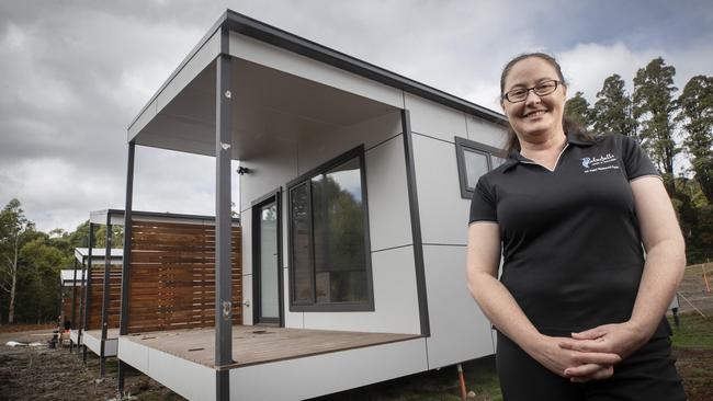 Rachel Power with the new accommodation pods under construction. Picture: Chris Kidd