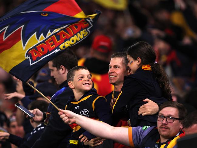 ADELAIDE, AUSTRALIA - MAY 02: Crows fans celebrate a goal during the 2024 AFL Round 08 match between the Adelaide Crows and the Port Adelaide Power at Adelaide Oval on May 02, 2024 in Adelaide, Australia. (Photo by James Elsby/AFL Photos via Getty Images)