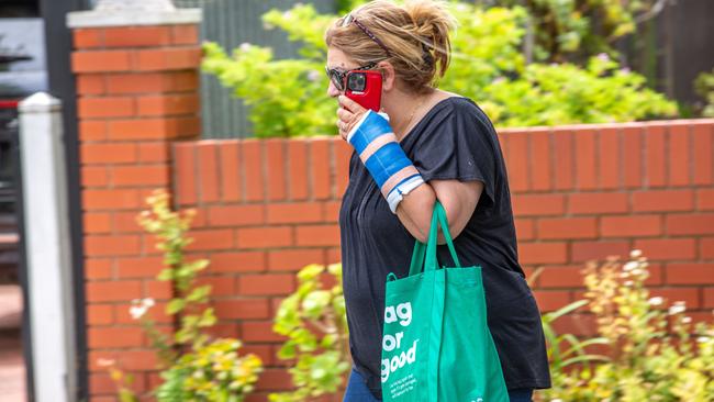 A family friend of Jacinta Davila, pictured with a cast on her left arm, outside Mary Davila’s Mile End home on Friday. Picture: Ben Clark