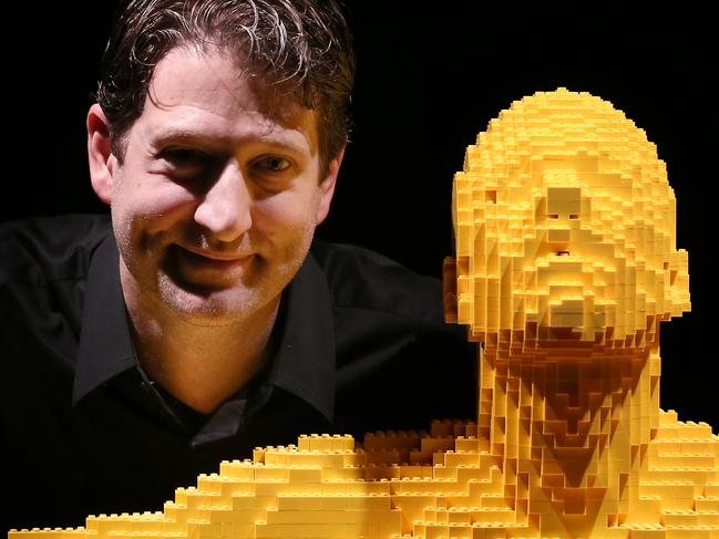 THE ART OF BRICK EXHIBITION .. LONDON, ENGLAND - SEPTEMBER 24: Artist Nathan Sawaya stands with his sculpture 'Yellow' at the Art of Brick Exhibition on September 24, 2014 in London, England. Eighty sculptures by artist Nathan Sawaya are on display at The Old Truman Brewery. Created from a million Lego bricks, the exhibition opens on September 26, 2014 and runs until January 4, 2015. (Photo by Peter Macdiarmid/Getty Images)