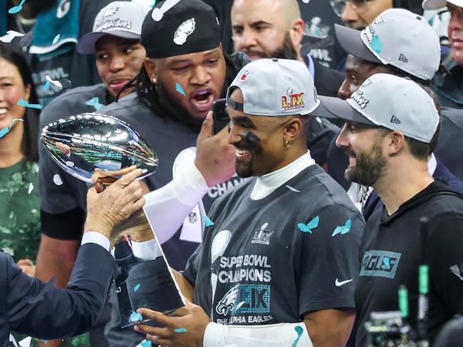 NEW ORLEANS, LOUISIANA - FEBRUARY 09: Philadelphia Eagles owner Jeffrey Lurie hands the Vince Lombardi Trophy to Jalen Hurts #1 after beating the Kansas City Chiefs 40-22 to win Super Bowl LIX at Caesars Superdome on February 09, 2025 in New Orleans, Louisiana. (Photo by Chris Graythen/Getty Images)