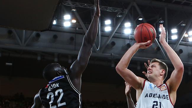 Adelaide’s Daniel Johnson shoots over Melbourne’s Majok Majok on Saturday night. Picture: Jack Thomas (Getty).