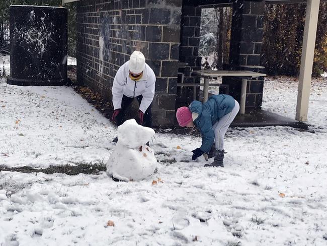 Kids build a snowman near Orange in the NSW Central West. Picture: Twitter