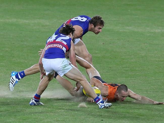 Slip, sliding away. Tom Scully brings up a cloud of sand.