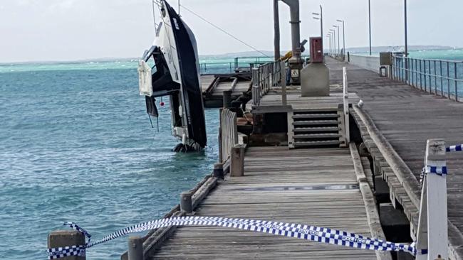 The boat is lifted by a crane on to the Beachport jetty. Picture: Luke Slater