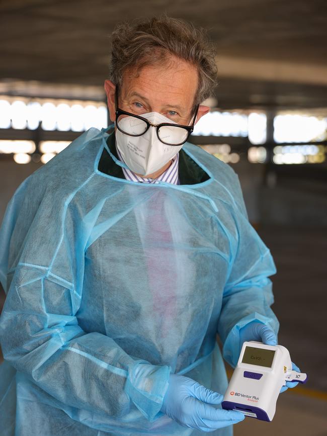 Dr John Saxon at Randwick Racecourse with a rapid testing Covid-19 test machine. Picture: Justin Lloyd.