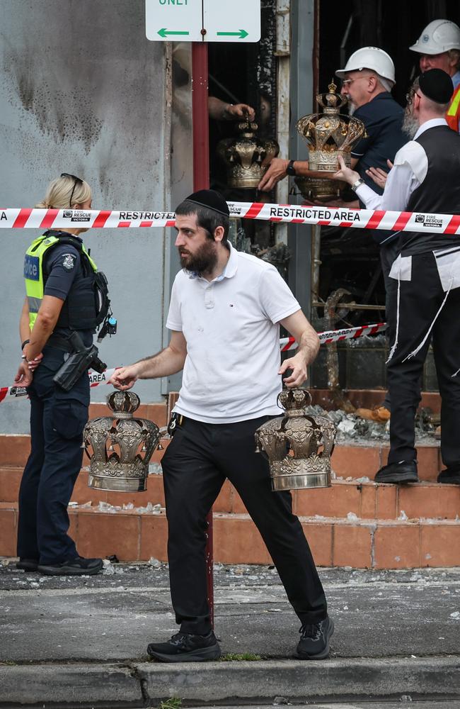 Members of the Jewish community remove religious artefacts. Picture: David Caird