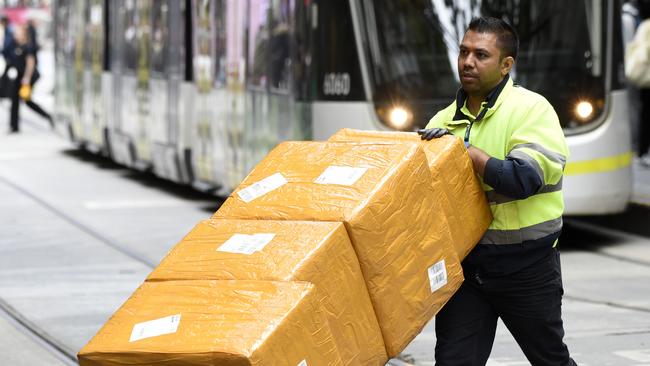 MELBOURNE, AUSTRALIA - NewsWire Photos DECEMBER 15, 2022: ABS generics - A delivery driver with boxes in the Bourke Street Mall in central Melbourne. Picture: NCA NewsWire / Andrew Henshaw