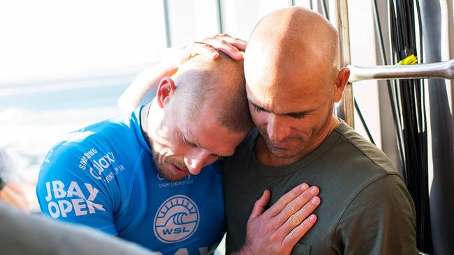 Mick Fanning is hugged by Kelly Slater