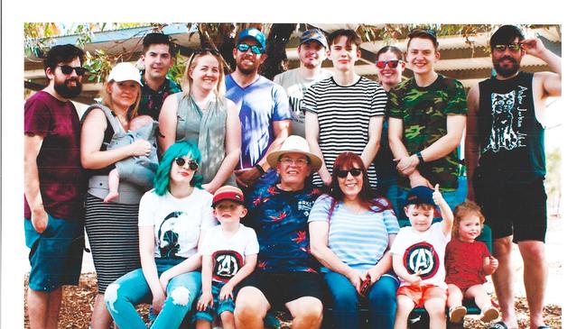 Garry Hill with his wife Diana, seated, and their nine children, two of their partners and four grandchildren. Garry lives with stage four prostate cancer so his wife Diana will be walking 72km to raise awareness for the disease. Picture: Supplied by family