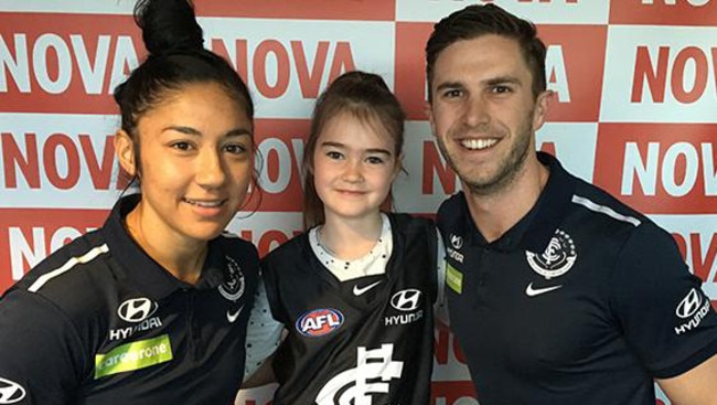 Jonathan Brown’s seven-year-old daughter Olivia with Carlton’s Darcy Vescio and Marc Murphy. Credit: Nova