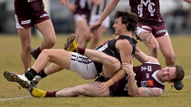 Melton’s Tom Button tackles Adam Azzopardi of Darley. Picture: Andy Brownbill