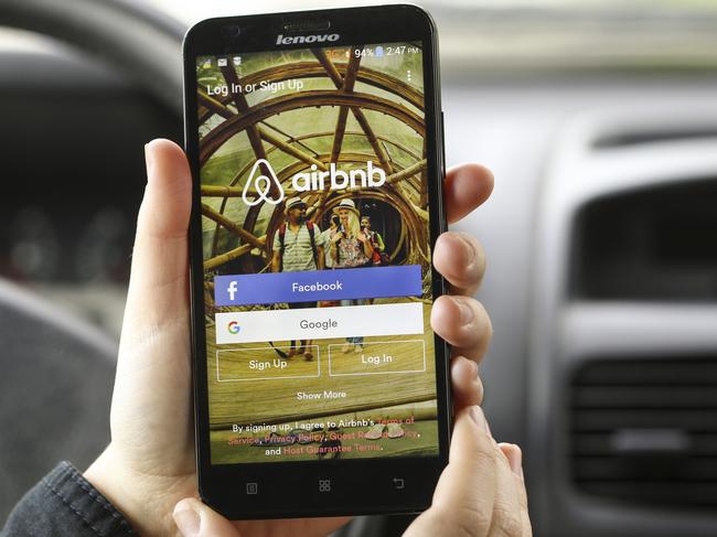 Novi Sad, Serbia - March 24, 2016: Close-up of an unrecognizable woman using the Airbnb App on her Lenovo A916 Android smartphone in a car. Login screen with Facebook and Google sign up options. Airbnb is a service for people to list, find, and rent lodging. It currently has over 1,500,000 listings in 34,000 cities and 190 countries.