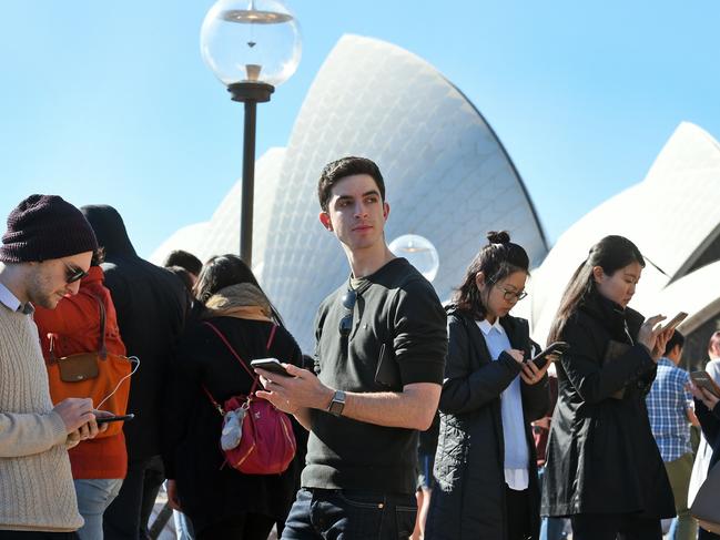 Dozens of people gather to play Pokemon Go in front of the Sydney Opera House. Picture: AFP