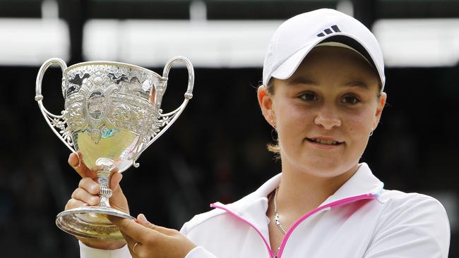 Barty holds up the trophy after defeating Russia’s Irina Khromacheva at Wimbledon in 2011.