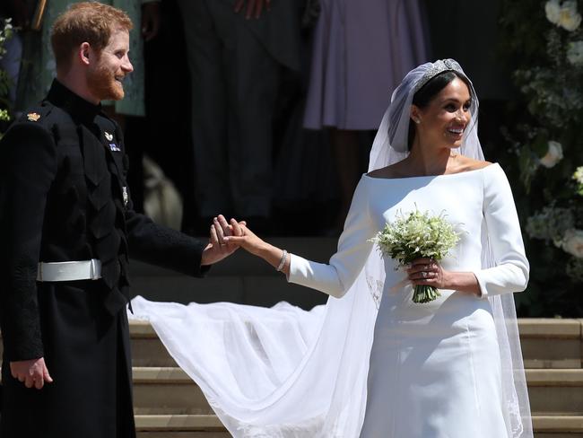 Britain's Prince Harry, Duke of Sussex and his wife Meghan, Duchess of Sussex emerge from the West Door of St George's Chapel, Windsor Castle, in Windsor, on May 19, 2018 after their wedding ceremony. Picture: Jane Barlow/AFP