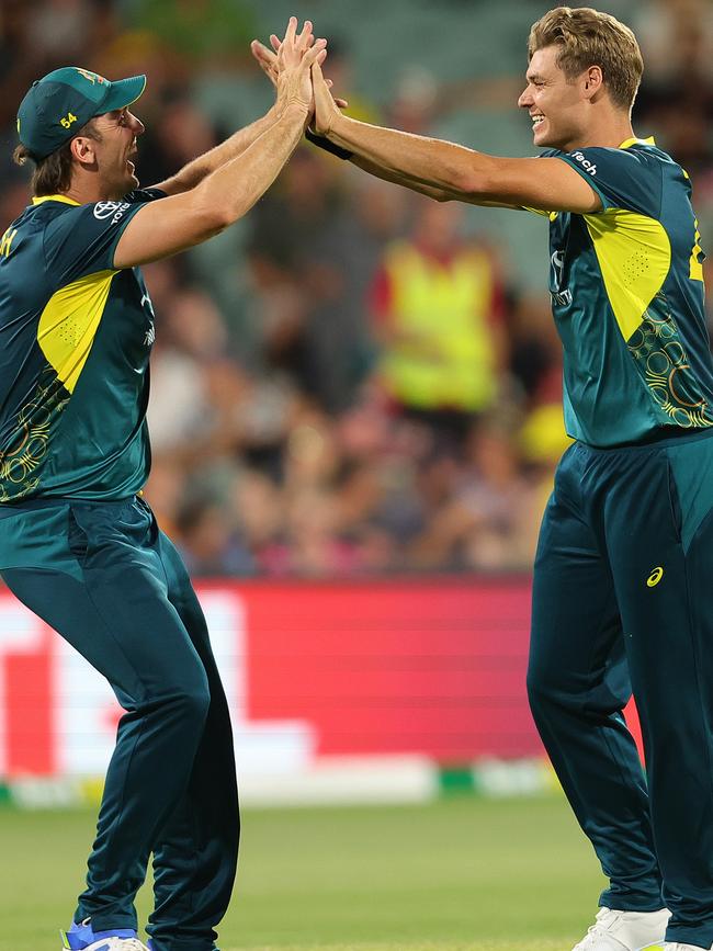 Spencer Johnson (right) celebrates with Mitch Marsh after taking a wicket for Australia in its T20 win against the West Indies at Adelaide Oval in February. Picture: Sarah Reed/Getty Images