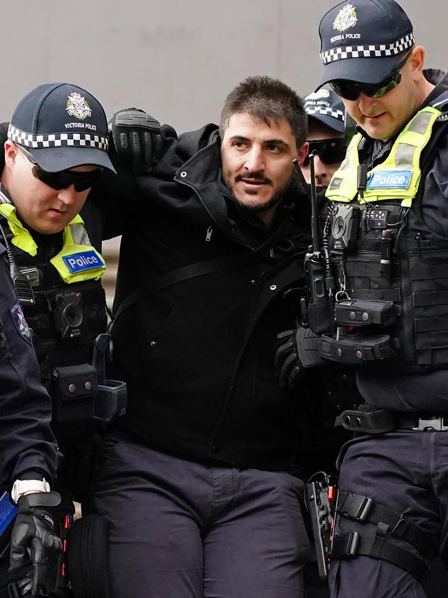 Rally organiser Fanos Panayides is detained by police in May 2020. Picture: AAP Image/Scott Barbour.