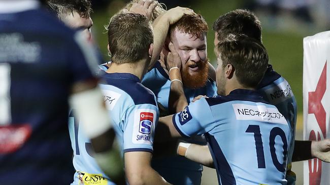 Harry Johnson-Holmes celebrates scoring a try for the Waratahs against the Rebels on Saturday night Picture: Getty Images