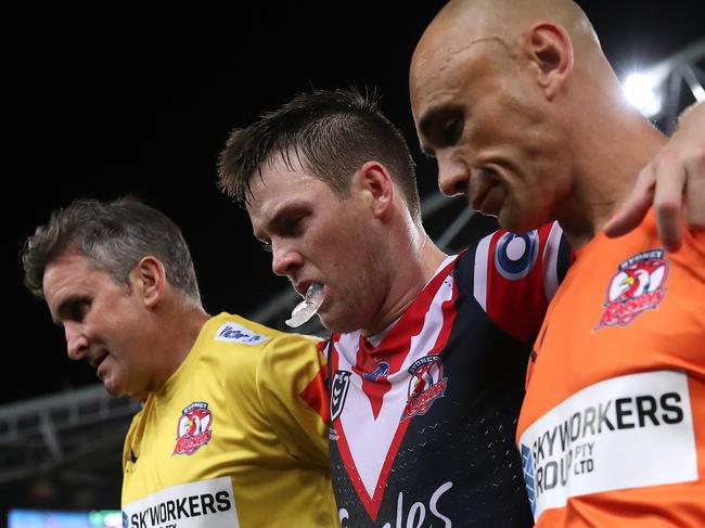 SYDNEY, AUSTRALIA - MARCH 26:  Luke Keary of the Roosters is helped off the field after a leg injury during the round three NRL match between the South Sydney Rabbitohs and the Sydney Roosters at Stadium Australia on March 26, 2021, in Sydney, Australia. (Photo by Cameron Spencer/Getty Images)