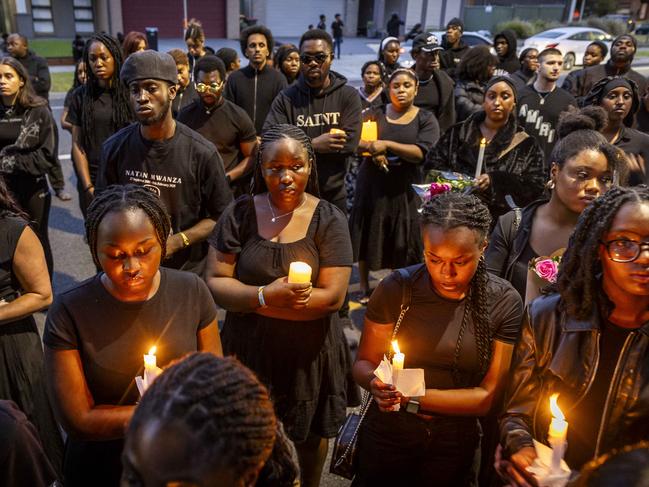 Mourners light candles in remembrance of Nathan. Picture: Jake Nowakowski