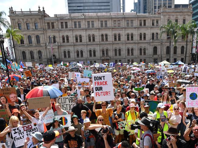 Climate change protestors are seen in Queens Gardens during the Global Strike 4 Climate rally in Brisbane, Friday, September 20, 2019. The Global Strike 4 Climate will take place in 110 towns and cities across Australia, with organisers demanding government and business commit to a target of net zero carbon emissions by 2030. (AAP Image/Darren England) NO ARCHIVING