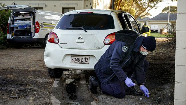 Crime Scene investigator looking at evidence on Fletcher Rd. Picture: Mike Burton.