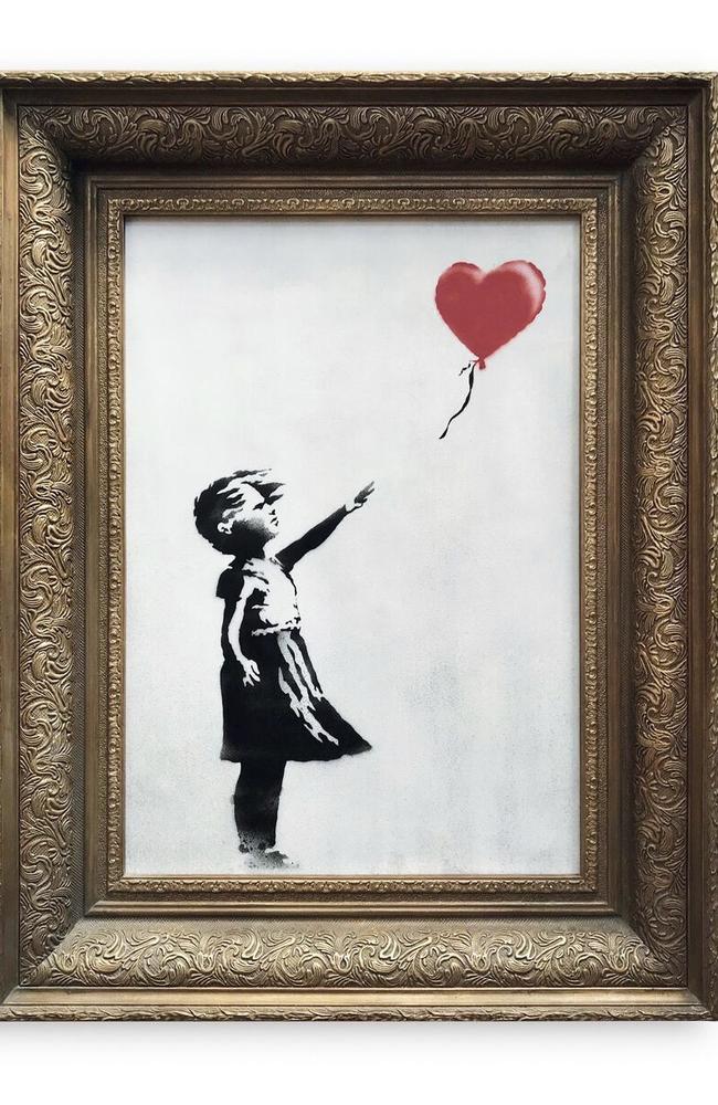 The spray-painted canvas 'Girl with Balloon' by Banksy selfdestructed in front of startled auction-goers on Friday, Oct. 5, 2018 moments after being sold for almost $A2 million. Picture: Sotheby's/AP