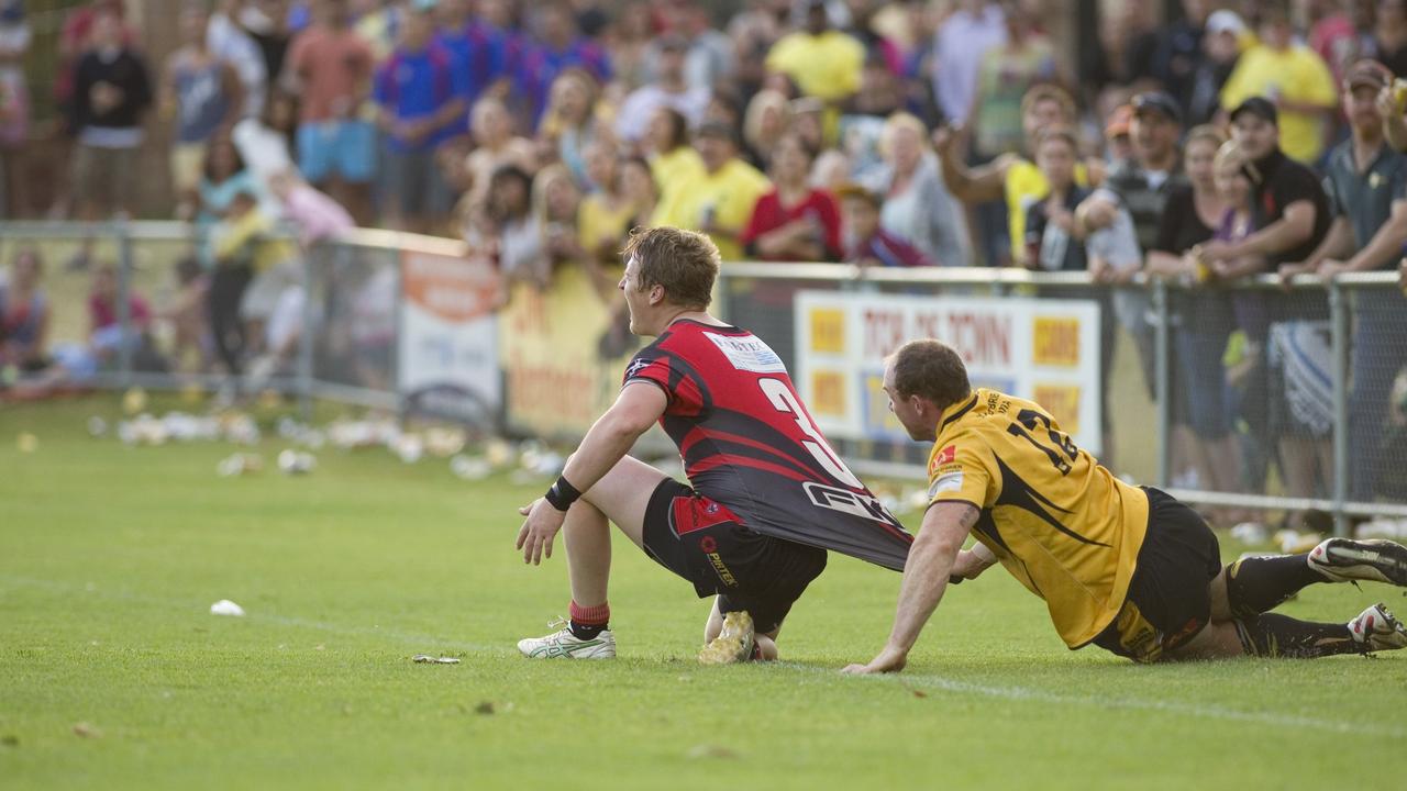 Hugh Sedger for Valleys is held by Gattons' Nick Kofoed behind the line. Photo Kevin Farmer / The Chronicle