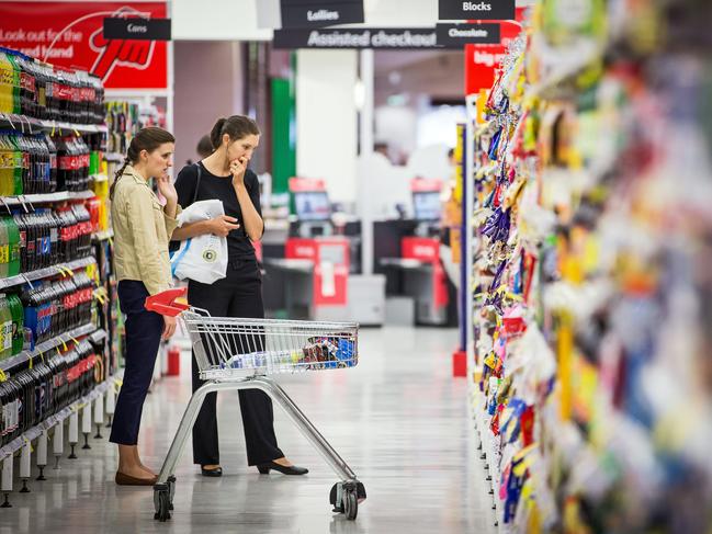 Shoppers browse in an aisle inside a Coles supermarket, operated by Wesfarmers Ltd., in Sydney, Australia, on Tuesday, Feb. 18, 2014. Wesfarmers, Australia's largest employer, is scheduled to report first-half earnings on Feb. 19. Photographer: Ian Waldie/Bloomberg via Getty Images