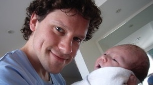 Dr Matthew Roberts with his baby.