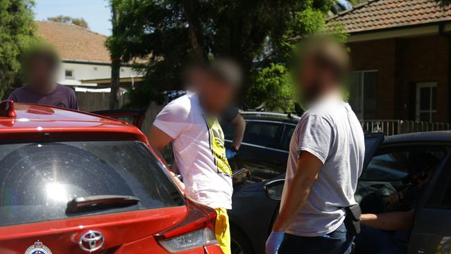 A man is arrested in Alt Street, Ashfield yesterday. Pictures: NSW Police