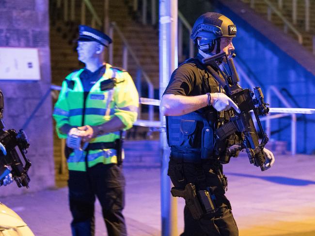 Police and other emergency services are seen near the Manchester Arena after reports of an explosion. Picture: Joel Goodman/LNP