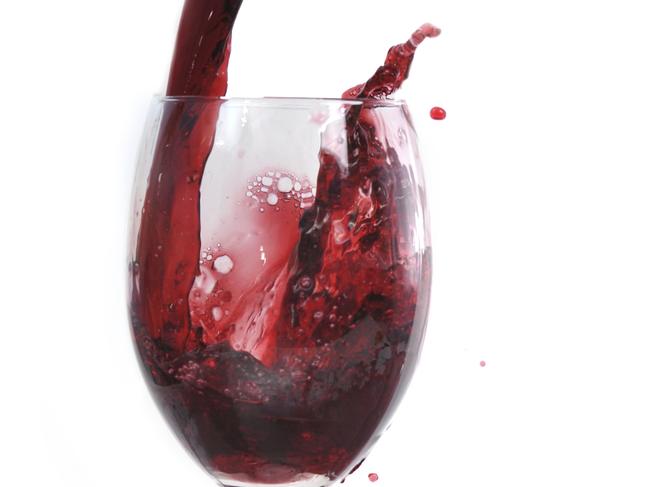 red wine flowing in transparent glass