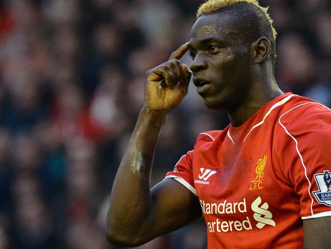 Liverpool's Italian forward Mario Balotelli reacts to the referees assistant during English Premier League football match between Liverpool and Hull City at the Anfield stadium in Liverpool, northwest England, on October 25, 2014. The match ended 0-0. AFP PHOTO / PAUL ELLIS RESTRICTED TO EDITORIAL USE. No use with unauthorized audio, video, data, fixture lists, club/league logos or “live” services. Online in-match use limited to 45 images, no video emulation. No use in betting, games or single club/league/player publications.