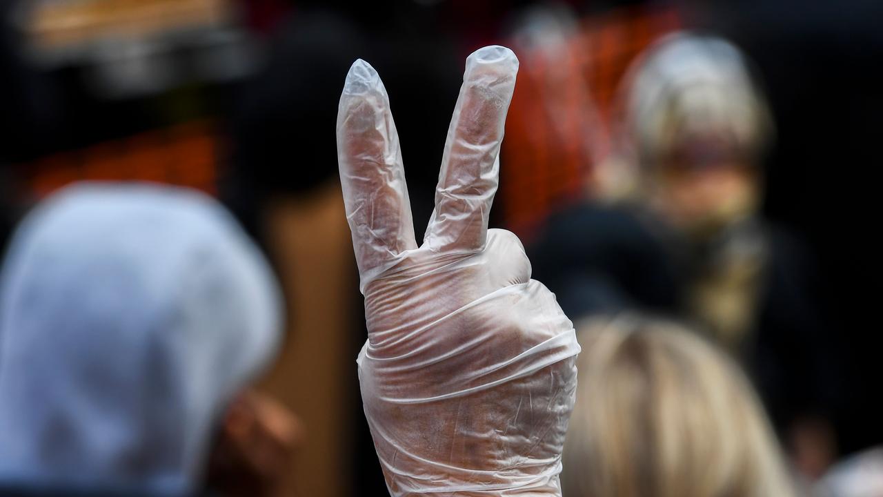 Protesters were encouraged to wear face masks and use hand sanitiser while marching. Picture: William West/AFP